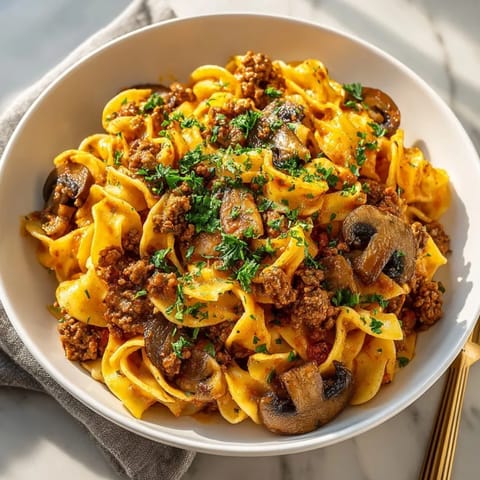 A close-up of a taco seasoned ground beef stroganoff, showcasing rich, meaty textures and sauce.