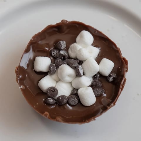 These delightful, homemade Budget-Friendly Hot Cocoa Bomb Cups are filled with marshmallows and cocoa mix.