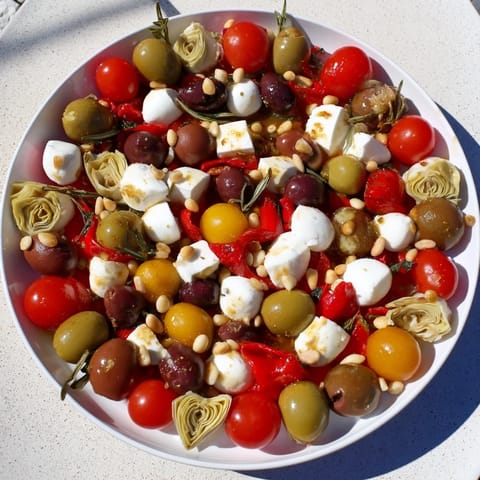This beautiful Olive and Cherry Tomato Garland Board is ready to serve with crusty bread for a delicious snack.