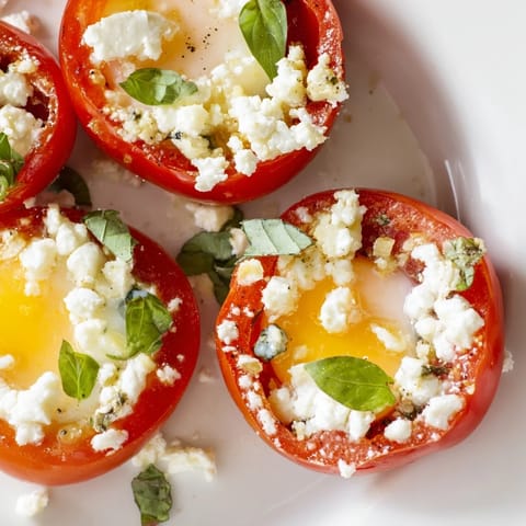 Golden-yolked Tomato Feta Baked Eggs, served with fresh basil; imagine the inviting aroma.