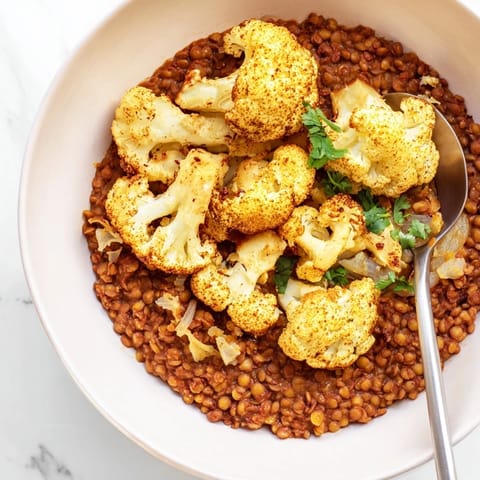 Dhal with Cumin-Roasted Cauliflower served over fluffy basmati rice with golden, spiced cauliflower florets.