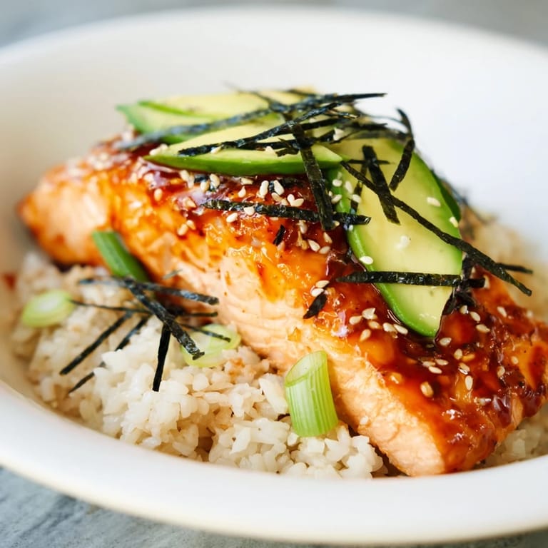 Close-up of a delicious Emily Mariko-inspired salmon bowl, showcasing the salmon's perfect glaze, and colorful toppings.