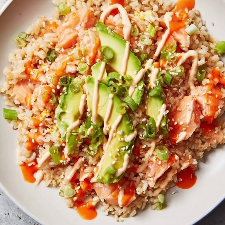 Enjoy a delicious Emily Mariko Salmon Rice Bowl, featuring flaked salmon and crunchy seaweed snacks.