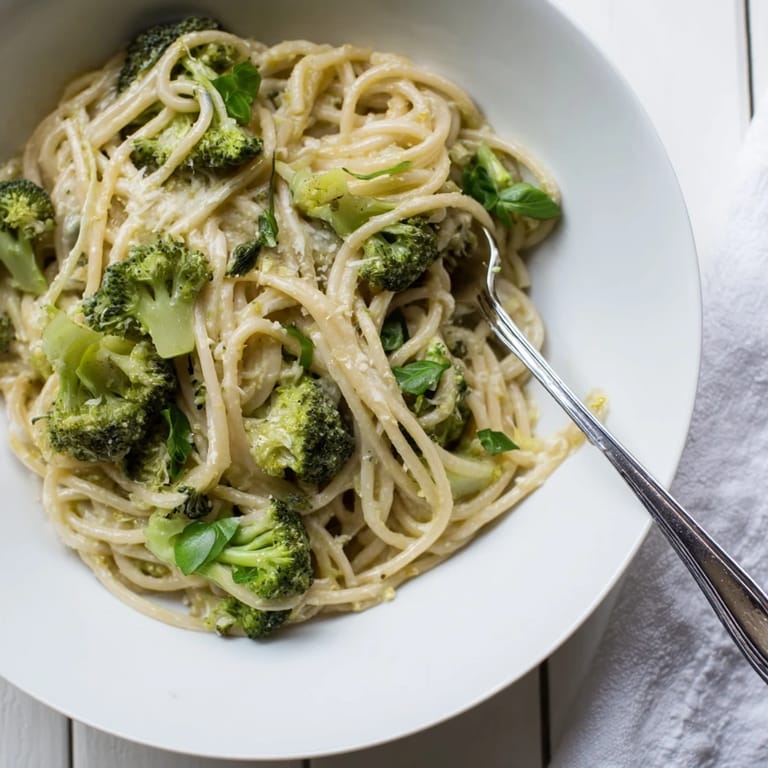 For a quick weeknight meal, One-Pot Lemon Broccoli Pasta is plated with a glass of crisp white wine and crusty bread.