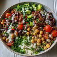Tossing the New Years Hoppin John Salad with black-eyed peas and chickpeas in a creamy tahini dressing.