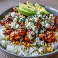 Street Corn Chicken Rice Bowls vibrant with colorful toppings and creamy sauce.